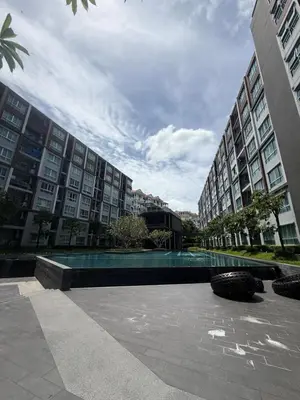 a large building with a swimming pool in front of it at Dcondo mine Kathu Phuket in Kathu