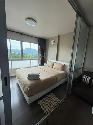a bedroom with a large bed and a window at Dcondo mine Kathu Phuket in Kathu