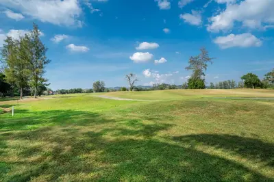 a view of a golf course with a large green field at Allamanda Laguna Phuket in Laguna Phuket
