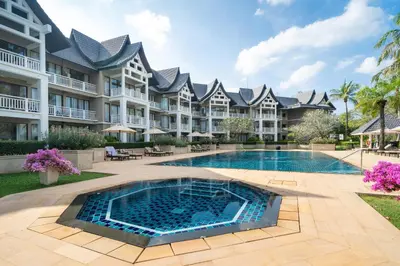 a large apartment building with a swimming pool at Allamanda Laguna Phuket in Laguna Phuket