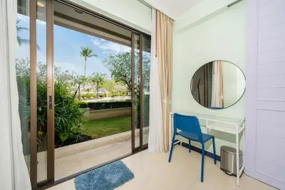 a room with a desk and a mirror at Allamanda Laguna Phuket in Laguna Phuket