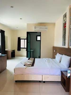 a bedroom with a large bed and a television at Royal Waves Hotel in Patong Beach
