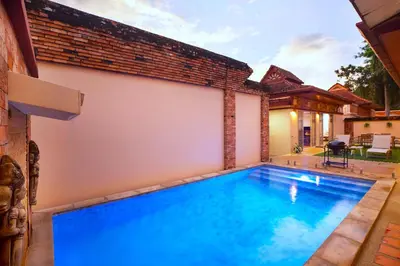 a swimming pool in the backyard of a house at Balinese 3BR Pool Villa Freya, Spacious Courtyard, 70 m from Stay Wellbeing & Lifestyle in Rawai Beach