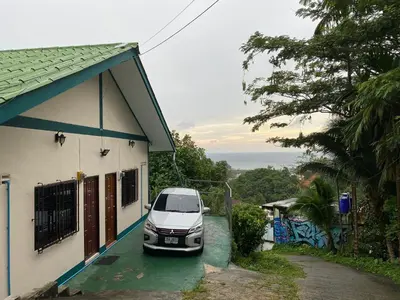a white car parked next to a house at Green House 2 in Ban Na Nai