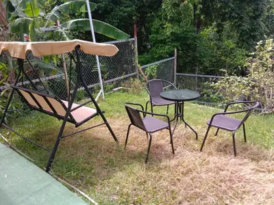 a group of chairs and a table and a table at Green House 2 in Ban Na Nai