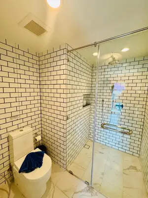 a bathroom with a toilet and a glass shower at Room Actually in Karon Beach