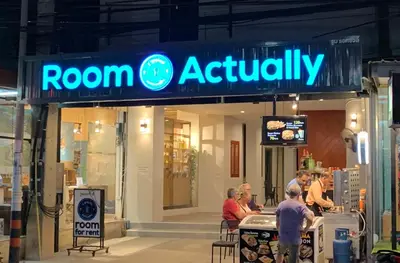 a group of people sitting in front of a room authority sign at Room Actually in Karon Beach