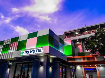 a building with a sign for a ski hotel at Siri Hotel Phuket in Phuket Town
