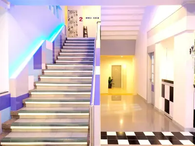 a set of stairs in a building with a hallway at Siri Hotel Phuket in Phuket Town
