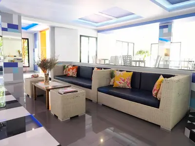 a living room with a couch and a table at Siri Hotel Phuket in Phuket Town