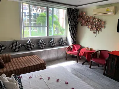 a living room with a bed and a window at Fong Kaew and Baan Nang Fa Guesthouse in Patong Beach