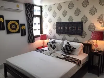a bedroom with two twin beds and two lamps at Fong Kaew and Baan Nang Fa Guesthouse in Patong Beach