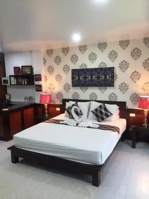 a bedroom with a large bed in a room at Fong Kaew and Baan Nang Fa Guesthouse in Patong Beach