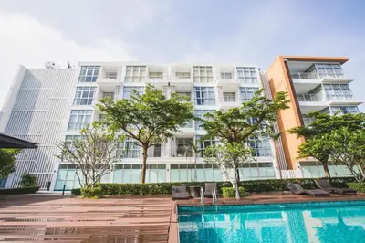 an apartment building with a swimming pool and trees at At Seacondo-1 Bedroom-A07 in Haad Klong Son