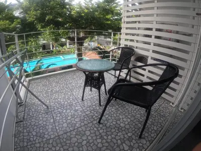 a patio with three chairs and a table on a balcony at At Seacondo-1 Bedroom-A07 in Haad Klong Son