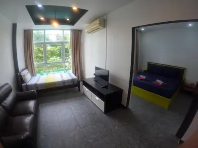 a living room with a mirror and a bed and a couch at At Seacondo-1 Bedroom-A07 in Haad Klong Son