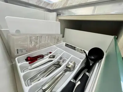 a drawer with silver utensils in a refrigerator at 2 BR Modern Pool Villa Chalong in Ban Suan