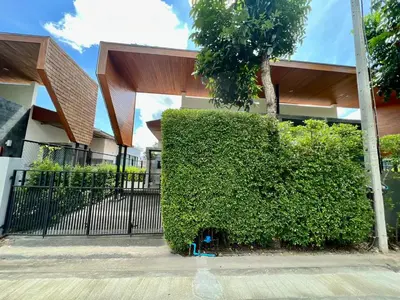 a large green bush in front of a building at 2 BR Modern Pool Villa Chalong in Ban Suan