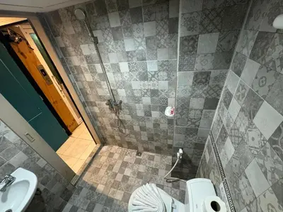 a bathroom with a shower and a toilet and a sink at Chilli Salza Patong in Patong Beach