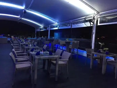 a restaurant with tables and chairs at night at Absolute Bangla Suites 69sqm with Jacuzzi in Patong Beach