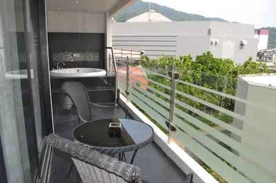 a balcony with a table and a sink on a building at Absolute Bangla Suites 69sqm with Jacuzzi in Patong Beach