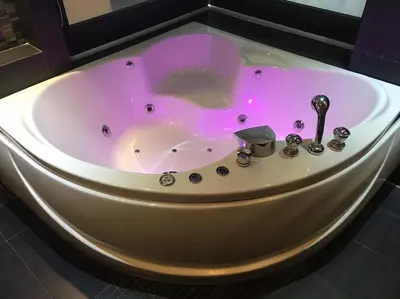 a white bath tub with a pink light in it at Absolute bangla suites 65 sqm with Jacuzzi in Patong Beach