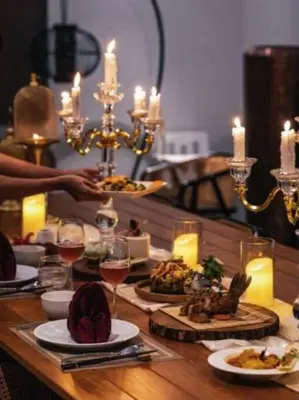 a table with plates of food and glasses of wine at \u9759\u6e7e\u4e4b\u8679VILLA SHOOWA Cape Yamu\u5962\u534e\u6d77\u666f\u522b\u5885 in Ban Bang La