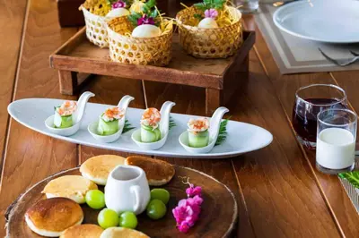 a table with a plate of food with eggs and bread at \u9759\u6e7e\u4e4b\u8679VILLA SHOOWA Cape Yamu\u5962\u534e\u6d77\u666f\u522b\u5885 in Ban Bang La