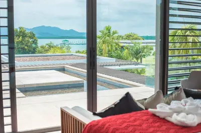 a living room with a view of a swimming pool at \u9759\u6e7e\u4e4b\u8679VILLA SHOOWA Cape Yamu\u5962\u534e\u6d77\u666f\u522b\u5885 in Ban Bang La