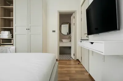 a living room with a tv and a bathroom at Halo 1 Title Naiyang beach in Phuket Town