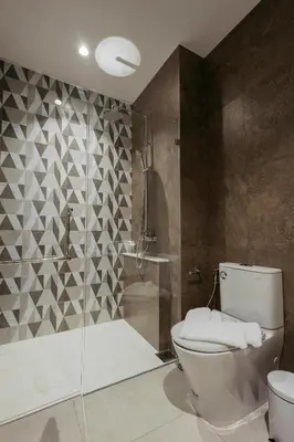 a bathroom with a toilet and a shower at Halo 1 Title Naiyang beach in Phuket Town