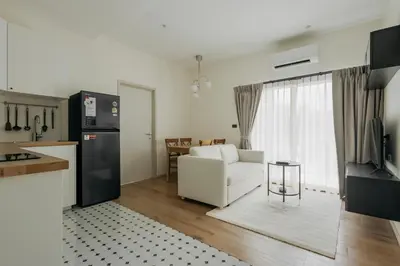 a kitchen and living room with a couch and a refrigerator at Halo 1 Title Naiyang beach in Phuket Town
