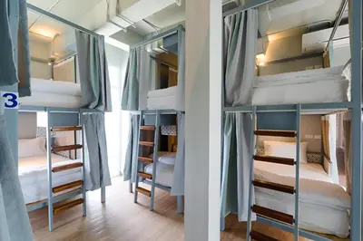 a group of bunk beds in a room at Friends Hostel - Phuket Airport in Nai Yang Beach