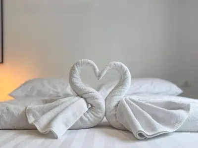 two towels in the shape of a heart on a bed at Garden View Apartment 1BR - NV-103 in Chalong