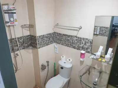 a small bathroom with a toilet and a shower at Monkey Apartment in Patong Beach