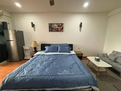 a bedroom with a large bed and a couch at Monkey Apartment in Patong Beach
