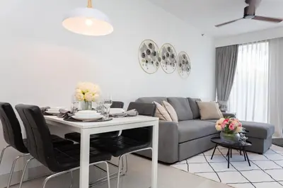 a living room with a table and a couch at Cassia 1BR City View apt by NLA in Bang Tao Beach