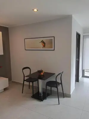 a dining room with a table and two chairs at Large Corner Apartment 1BR - NV-207 in Chalong