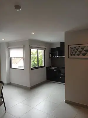 a large kitchen with two windows in a room at Large Corner Apartment 1BR - NV-207 in Chalong