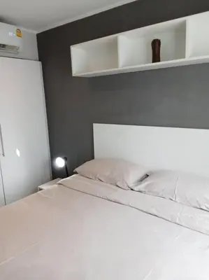 a bedroom with a white bed with a white headboard at Large Corner Apartment 1BR - NV-207 in Chalong