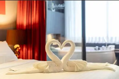 two white swans making a heart on a bed at Studio Apartment in Bangla Rd in Patong Beach
