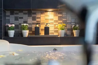 a window of a bathroom with flower pots and a bath tub at Studio Apartment in Bangla Rd in Patong Beach