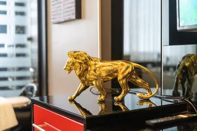 a gold statue of a lion on a desk at Studio Apartment in Bangla Rd in Patong Beach