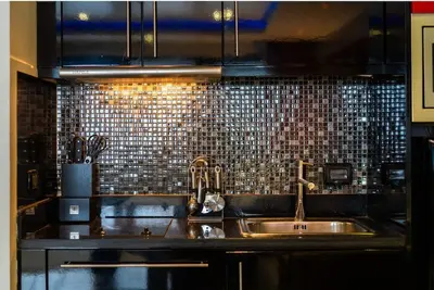 a kitchen with a sink and a tile back splash at Studio Apartment in Bangla Rd in Patong Beach