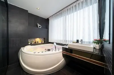 a large bathroom with a tub and a sink at Studio Apartment in Bangla Rd in Patong Beach
