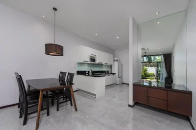 a kitchen and dining room with a table and chairs at Saiyuan Estate by TropicLook in Rawai Beach