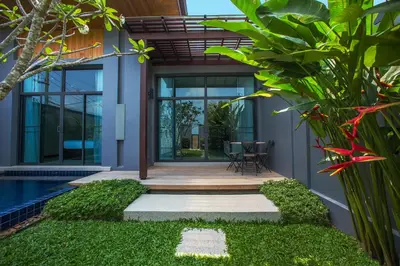 a house with a swimming pool and a patio at Saiyuan Estate by TropicLook in Rawai Beach