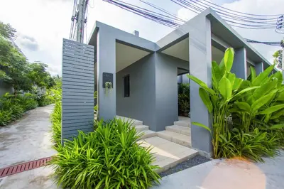 a house with a lot of plants in front of it at Saiyuan Estate by TropicLook in Rawai Beach