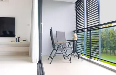 a room with a desk and a laptop on a balcony at Cassia 3BR Sea View apt by NLA in Bang Tao Beach