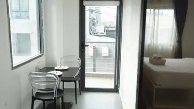 a room with a bed and a table and chairs at Big Buddha View Apt-1BR T1-306 in Chalong